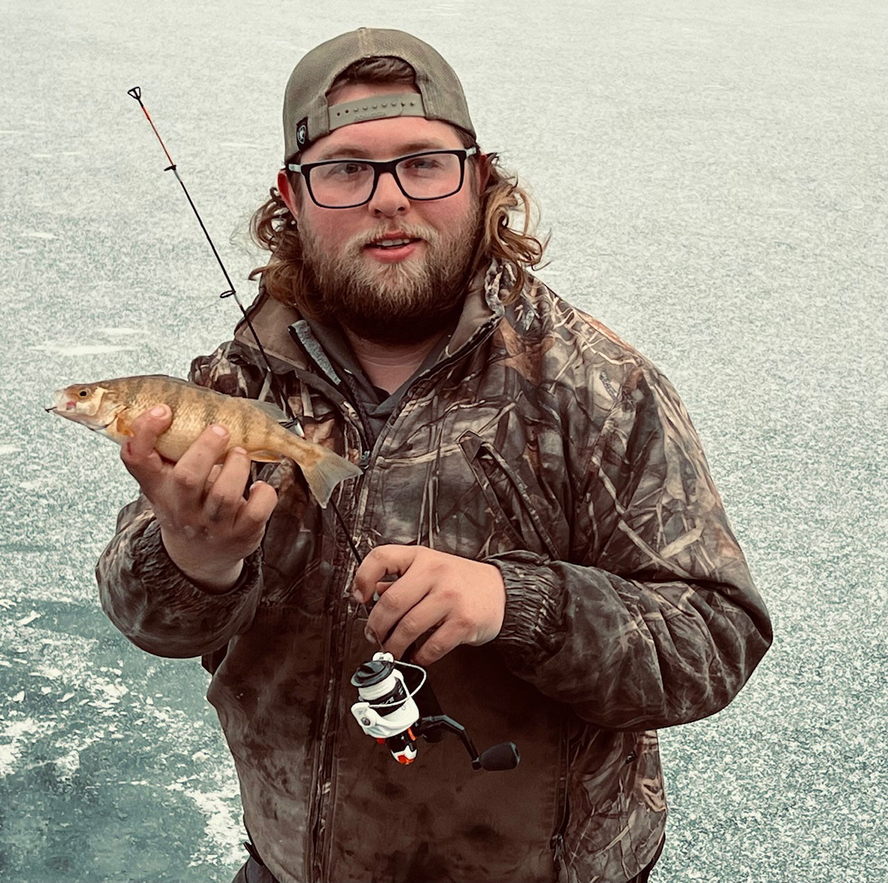 Tyler Bergquist fishing on the ice at Red Rock Lake, showcasing a productive perch outing.