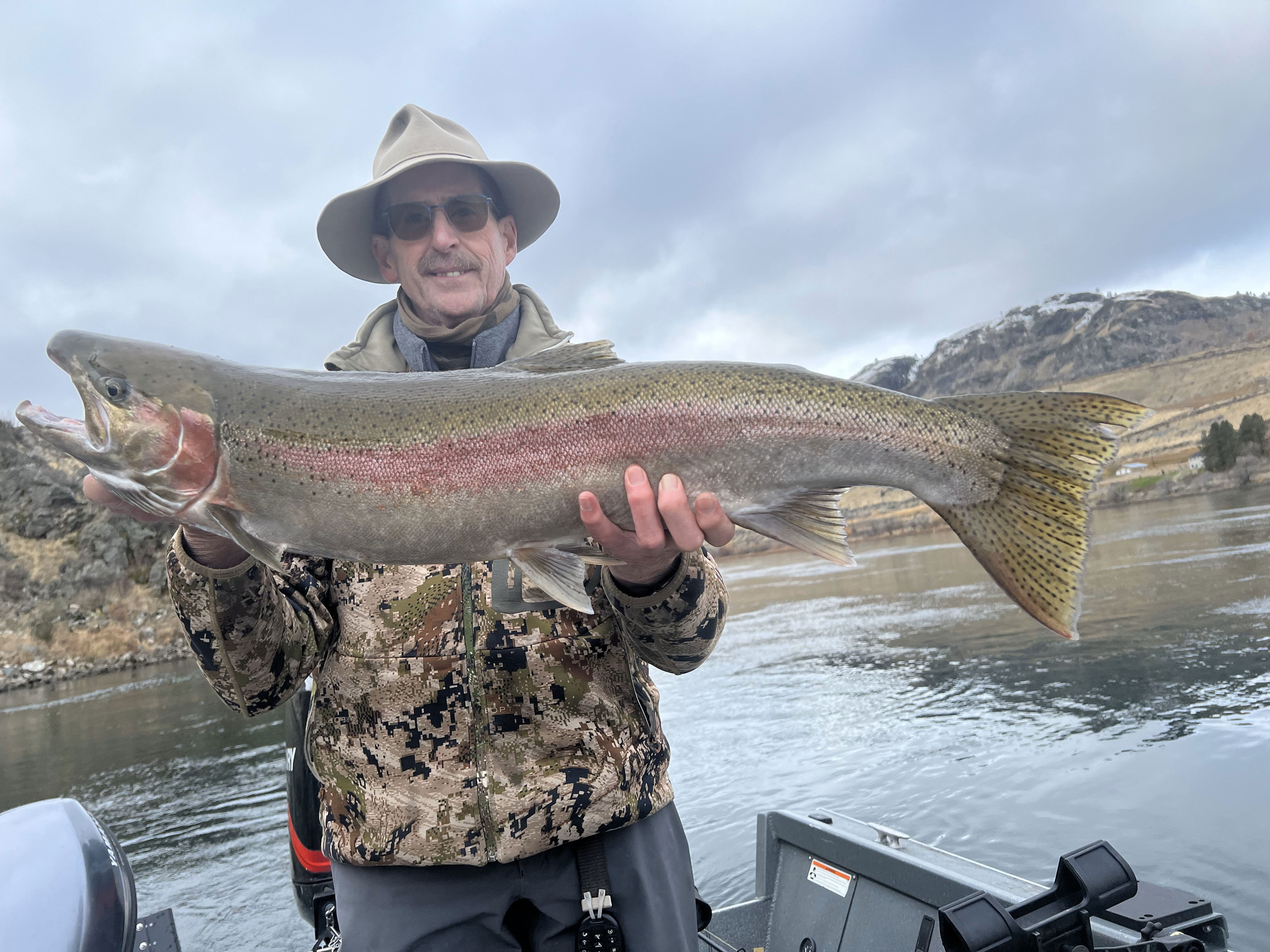 Brother Rick holding a large hatchery steelhead caught near Pateros, showcasing winter angling success.