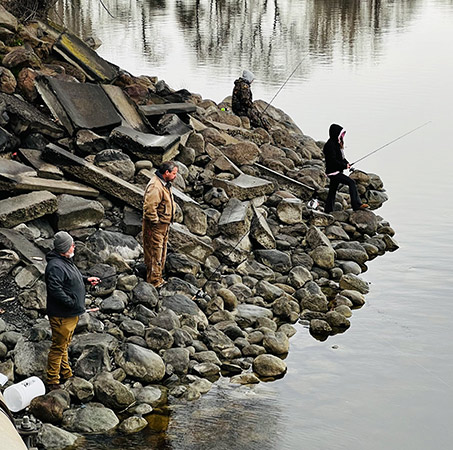 anglers fishing on the rip rap near the I-90 Bridge