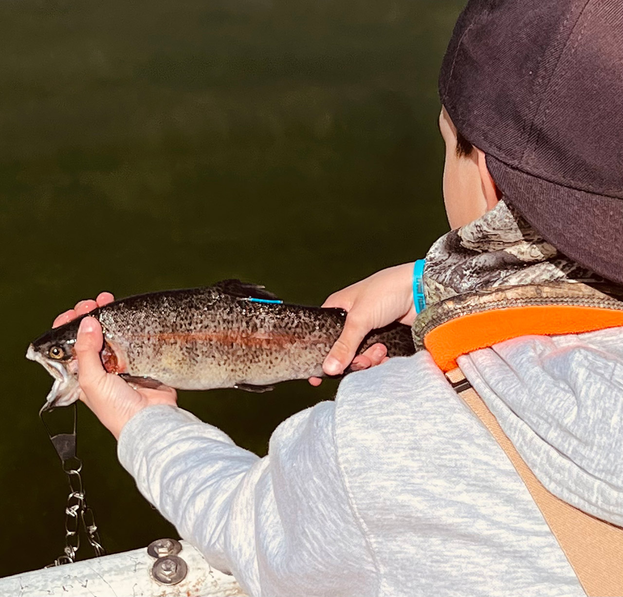 young angler showing the tag that everyone will be looking for to know they have a winning fish.