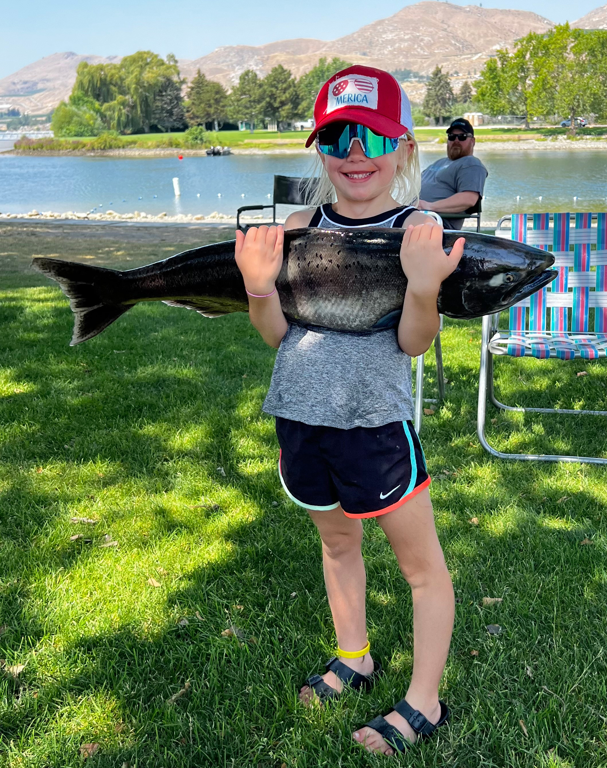 Four-year-old Beau Benson hugging a salmon she caught at the Brewster King Salmon Derby, which placed second in the 8 and under category.