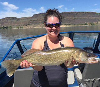 Whitney holding a large walleye she caught at Banks Lake, showcasing her successful fishing trip.